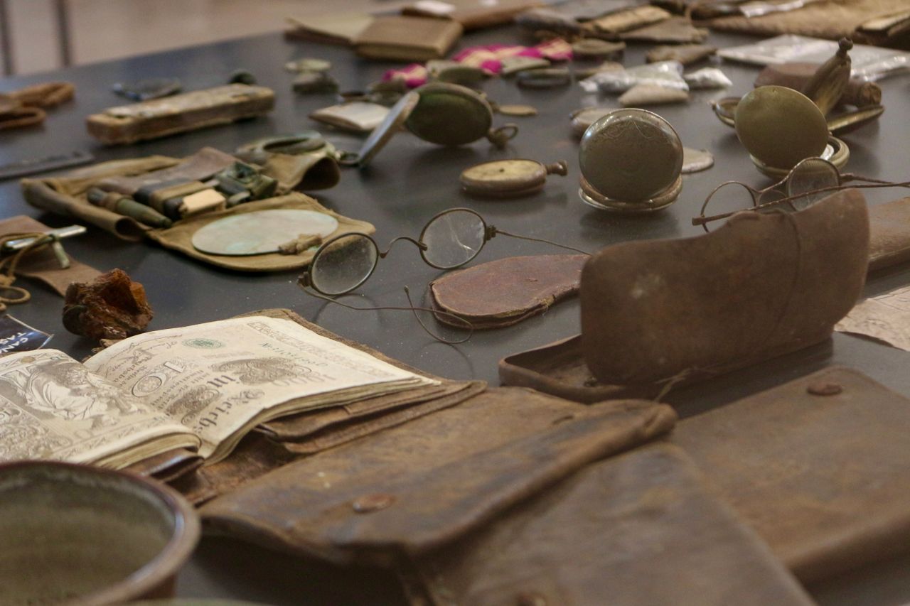 A detailed view of antique artifacts including glasses and documents on display.